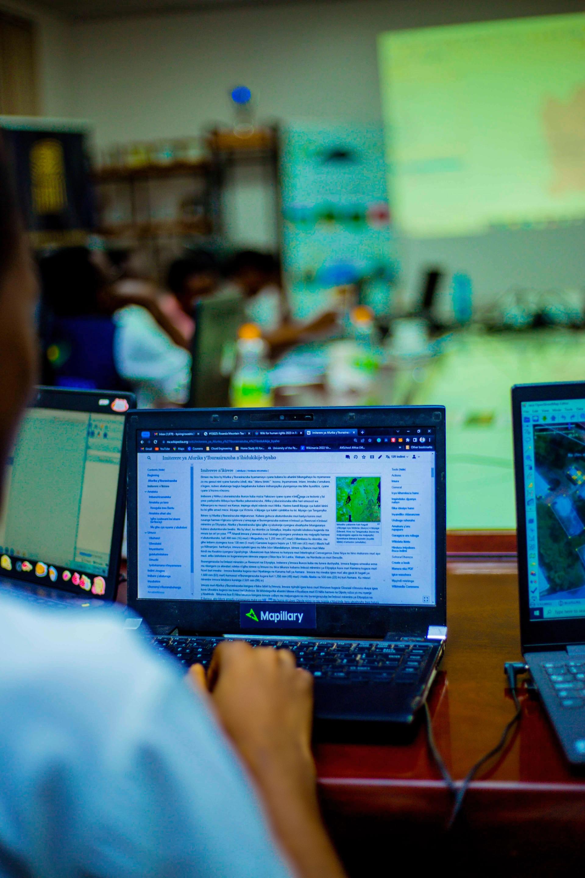 A person uses a computer in Rwanda. 