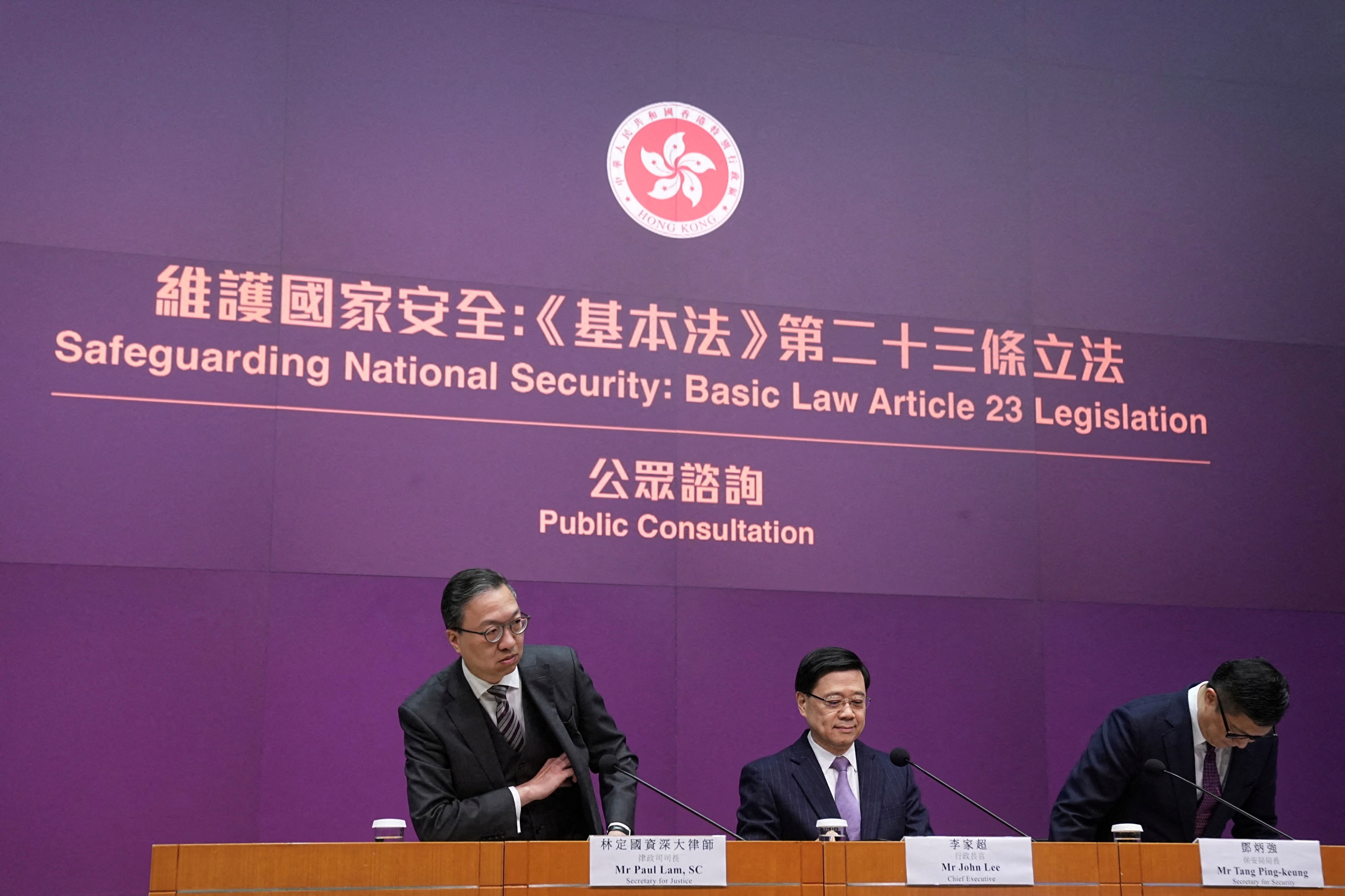 Hong Kong’s Secretary for Justice Paul Lam, Chief Executive John Lee and Secretary for Security Chris Tang Ping-keung attend a press conference regarding the legislation of Article 23 national security laws, in Hong Kong.