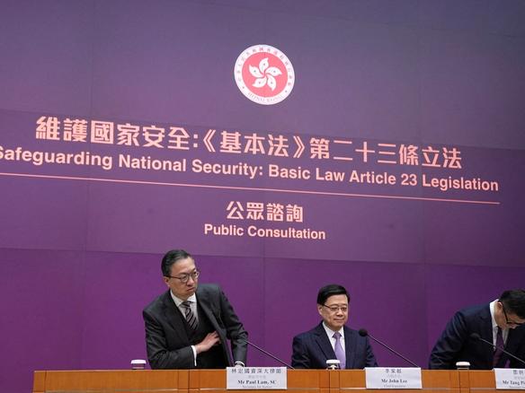 Hong Kong's Secretary for Justice Paul Lam, Chief Executive John Lee and Secretary for Security Chris Tang Ping-keung attend a press conference regarding the legislation of Article 23 national security laws, in Hong Kong.