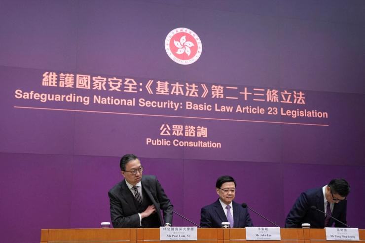 Hong Kong’s Secretary for Justice Paul Lam, Chief Executive John Lee and Secretary for Security Chris Tang Ping-keung attend a press conference regarding the legislation of Article 23 national security laws, in Hong Kong.
