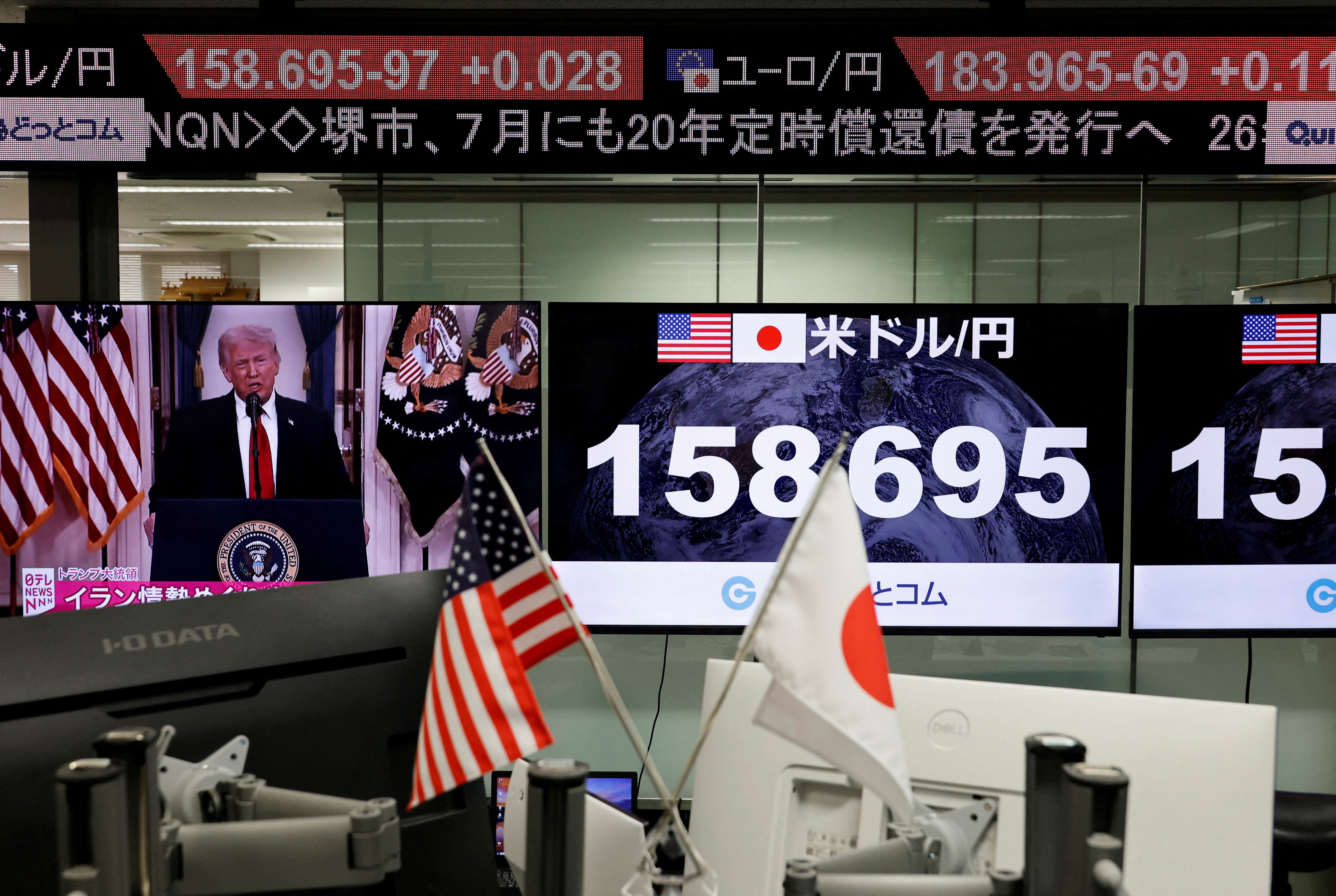 A TV screen broadcasts U.S. President Donald Trump’s speech about the Iran war next at the foreign exchange trading company in Tokyo.