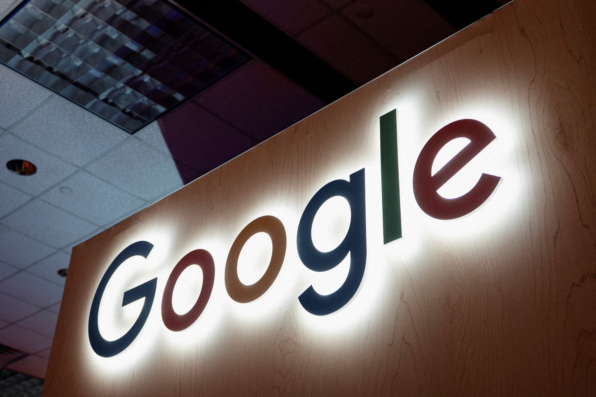 Illuminated Google sign in a dark office