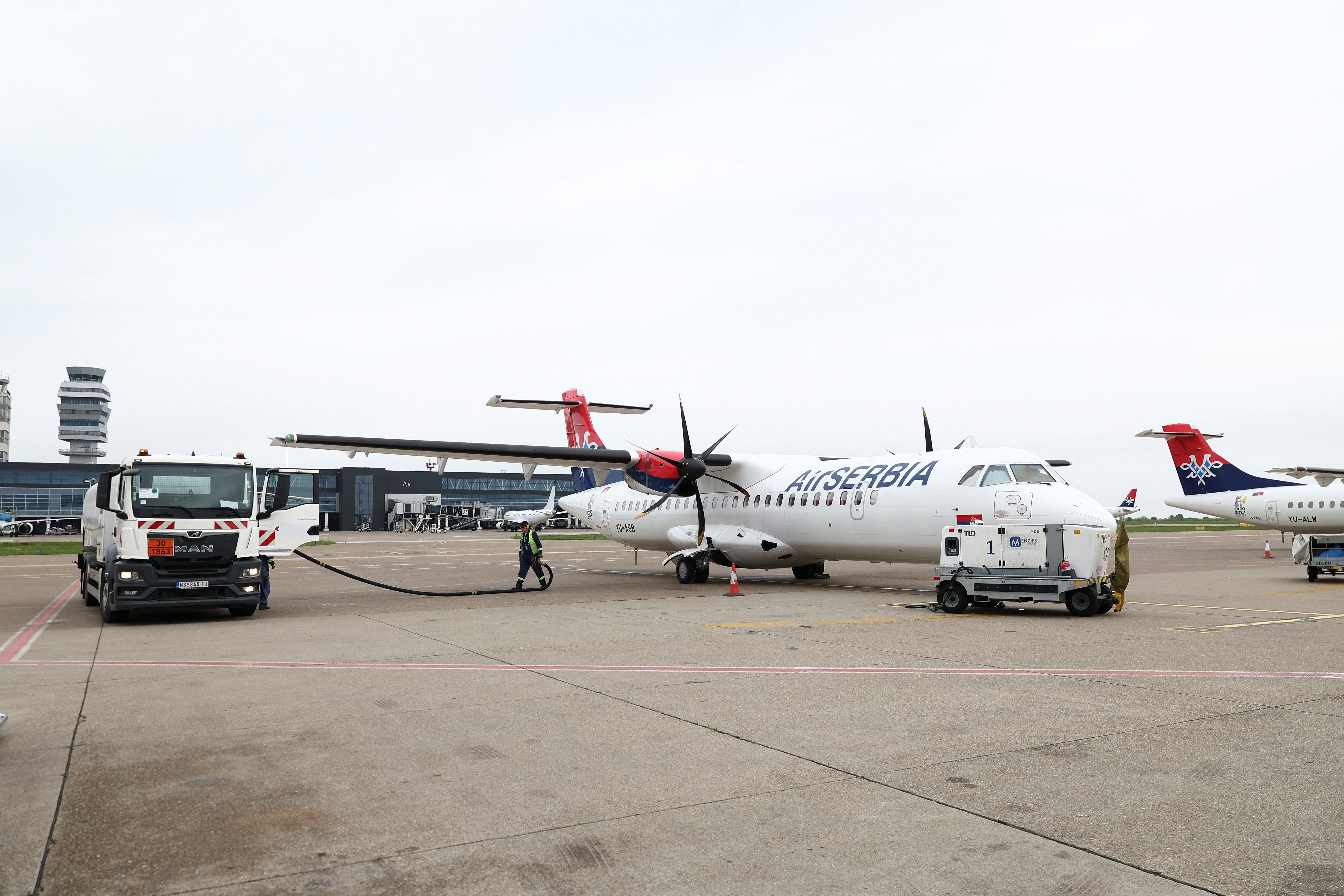 Workers refuel a plane at Belgrade Nikola Tesla airport as airports across Central and Eastern Europe are bracing for potential jet fuel shortages and flight disruptions linked to the Middle East crisis