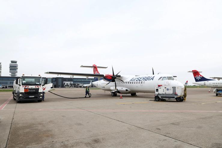 Workers refuel a plane at Belgrade Nikola Tesla airport as airports across Central and Eastern Europe are bracing for potential jet fuel shortages and flight disruptions linked to the Middle East crisis