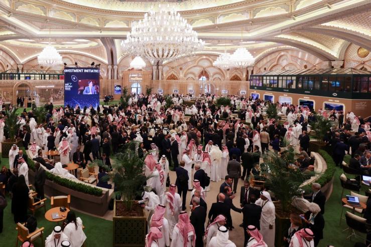 Attendees gather in the lobby of the Exhibition and Conference Center of the Ritz Carlton Hotel during the first day of the Future Investment Initiative conference, in Riyadh, 2022.