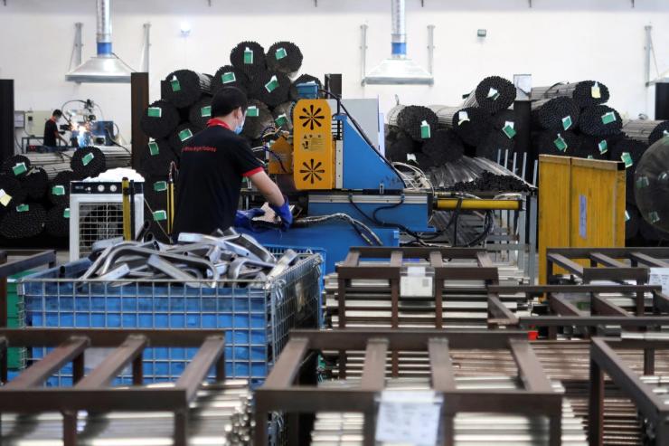 Employees work on the production line of American infant product and toy manufacturer Kids II Inc. at a factory in Jiujiang.