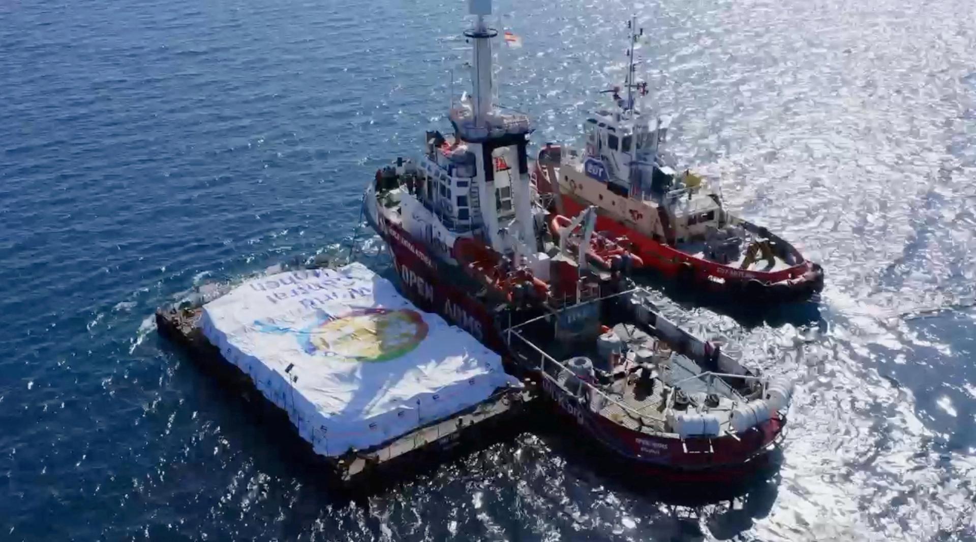 Aid ship sails, amidst a test to launch a new sea route from a port in Cyprus to deliver aid to residents of the Gaza Strip who are on the brink of famine, at sea, March 12, 2024, in this screen grab from a handout video. World Central Kitchen/Handout via REUTERS