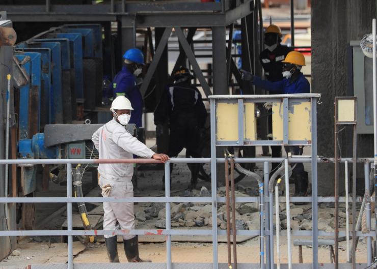 Workers work at Prospect Lithium Zimbabwe mine in Goromonzi, Zimbabwe.