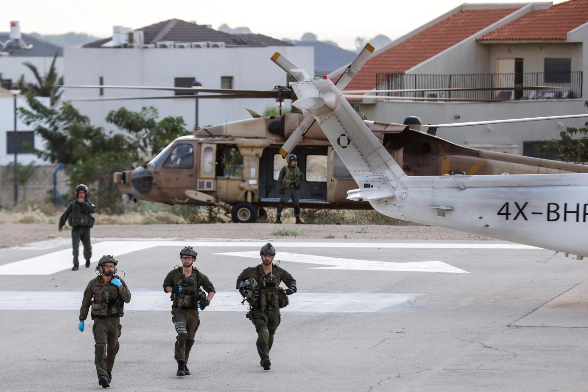 Israeli soldiers are seen near a military helicopter at a hospital following a mass-infiltration by Hamas gunmen from the Gaza Strip, in Ashkelon, southern Israel October 7, 2023. REUTERS/Amir Cohen
