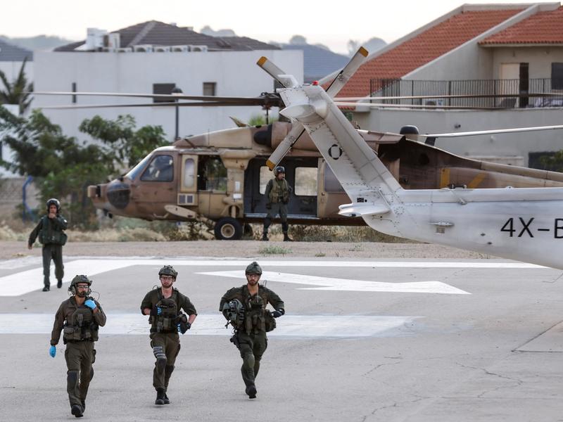 Israeli soldiers are seen near a military helicopter at a hospital following a mass-infiltration by Hamas gunmen from the Gaza Strip, in Ashkelon, southern Israel October 7, 2023. REUTERS/Amir Cohen