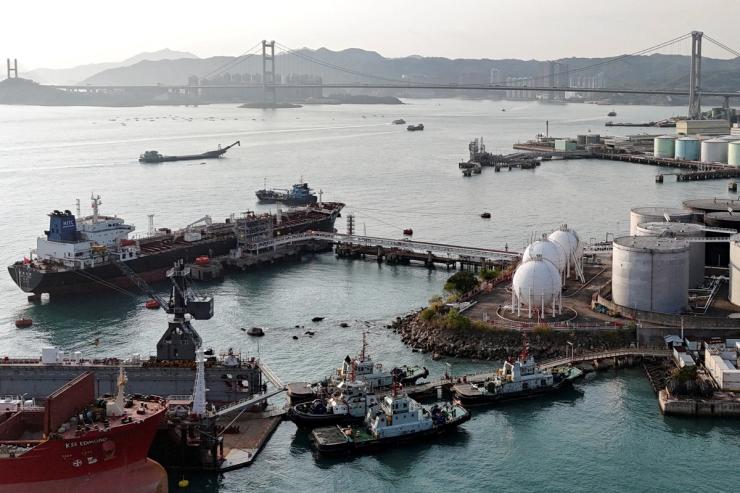 A drone view shows a Chinese-flagged oil tanker moored at an oil terminal at Tsing Yi port, with Tsing Ma bridge in the background, in Hong Kong, China
