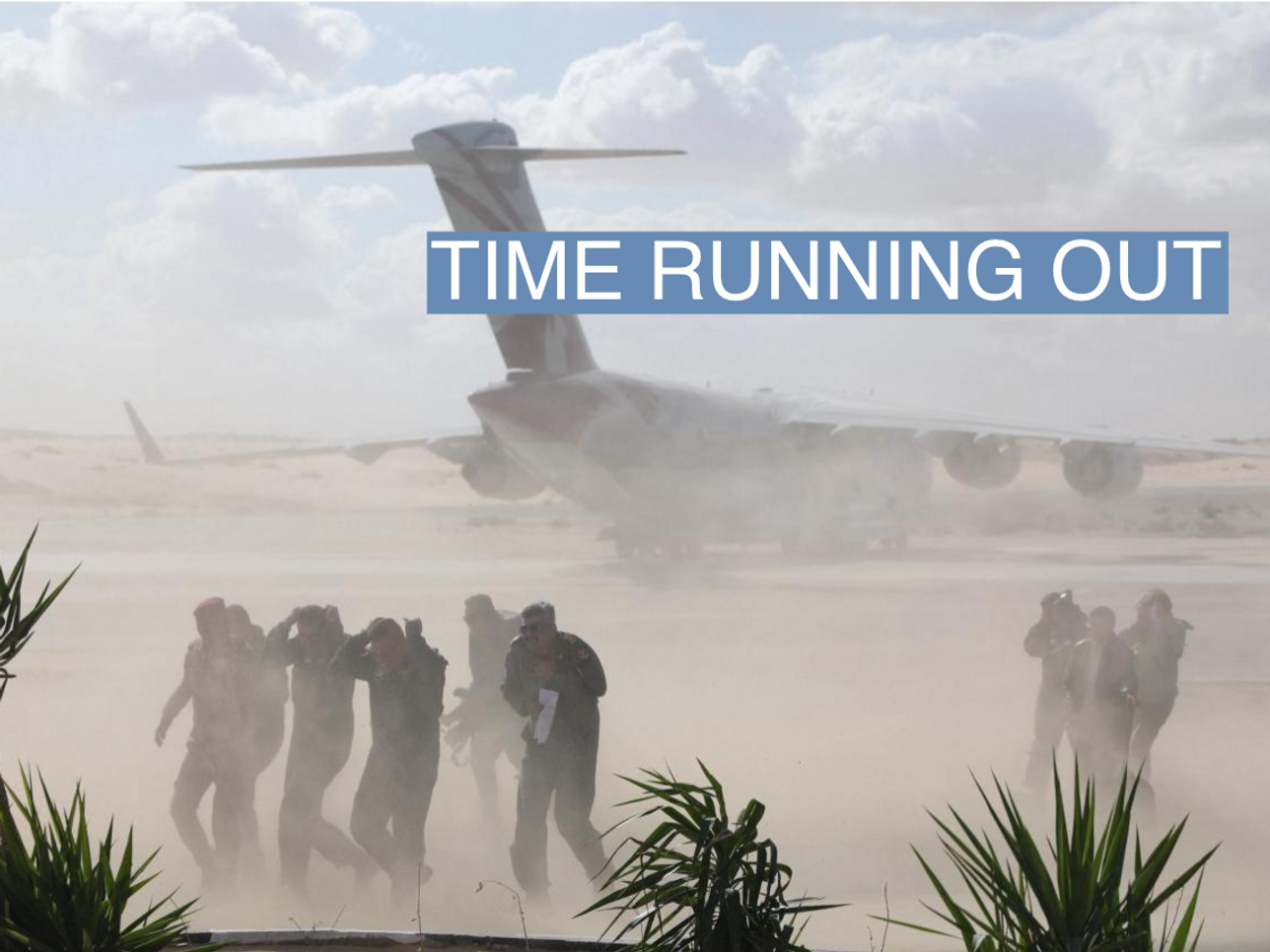 Members of the media run for cover from sand as airplanes, transporting humanitarian aid destined for the Gaza Strip via Rafah border area, land at Al Arish airport, during a temporary truce between Palestinian Islamist group Hamas and Israel, in Egypt, November 27, 2023. REUTERS/Amr Abdallah Dalsh