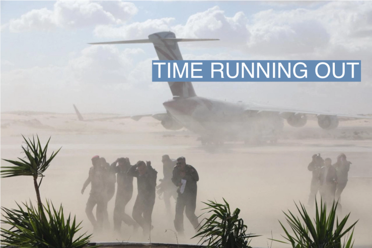 Members of the media run for cover from sand as airplanes, transporting humanitarian aid destined for the Gaza Strip via Rafah border area, land at Al Arish airport, during a temporary truce between Palestinian Islamist group Hamas and Israel, in Egypt, November 27, 2023. REUTERS/Amr Abdallah Dalsh
