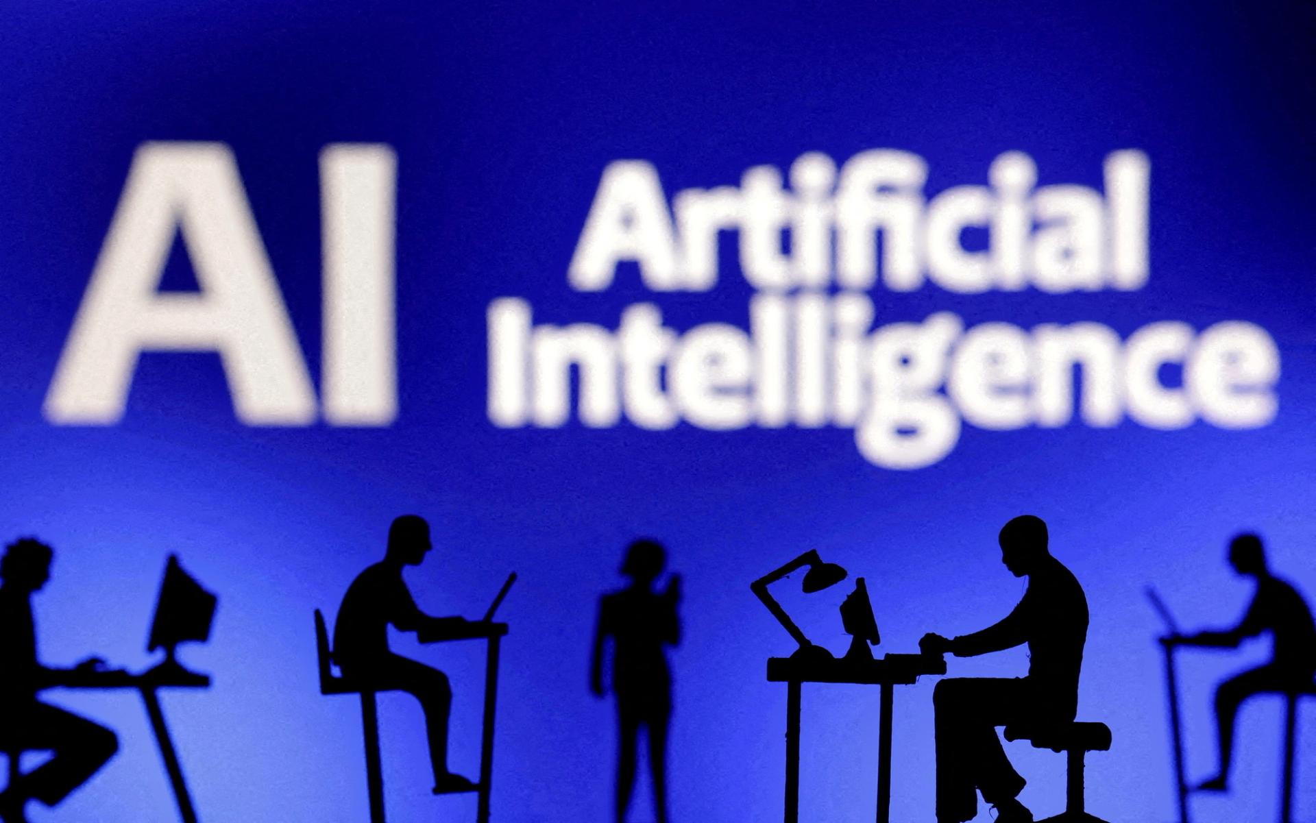 FILE PHOTO: Figurines with computers and smartphones are seen in front of the words “Artificial Intelligence AI” in this illustration taken, February 19, 2024. REUTERS/Dado Ruvic/Illustration/File Photo