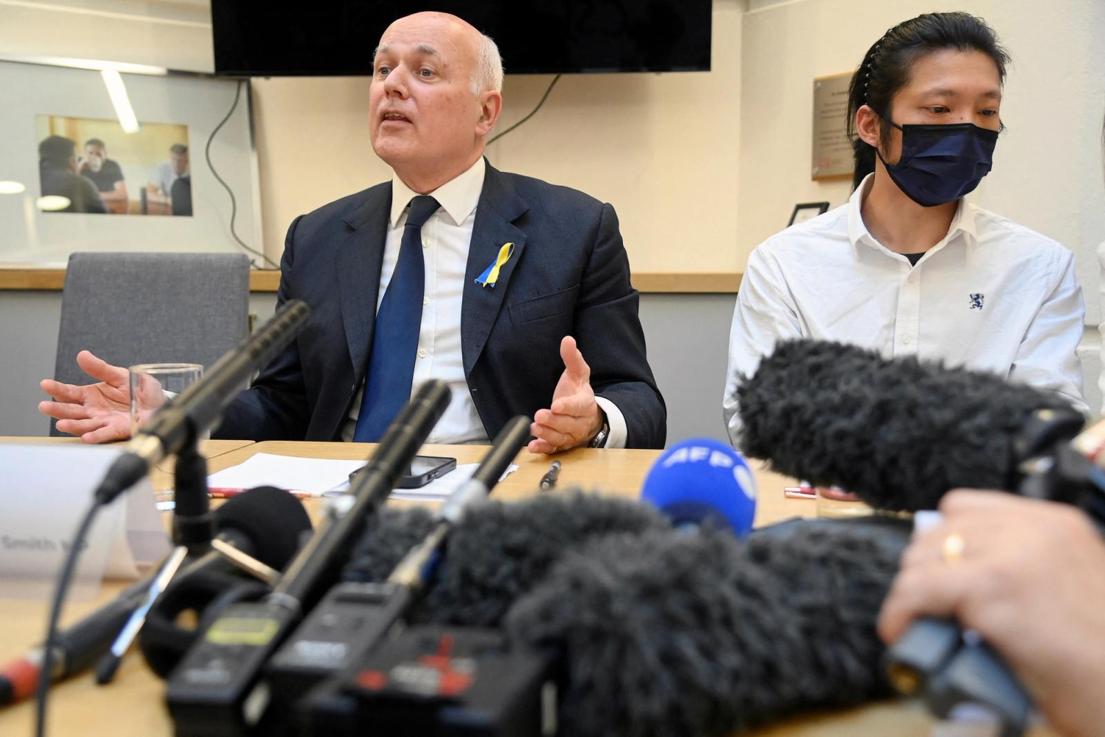 British MP Iain Duncan Smith speaks during a news conference, while sat next to protester Bob Chan, who was seen being pulled into the grounds of a Chinese consulate in Manchester and beaten, in London, Britain, October 19, 2022.