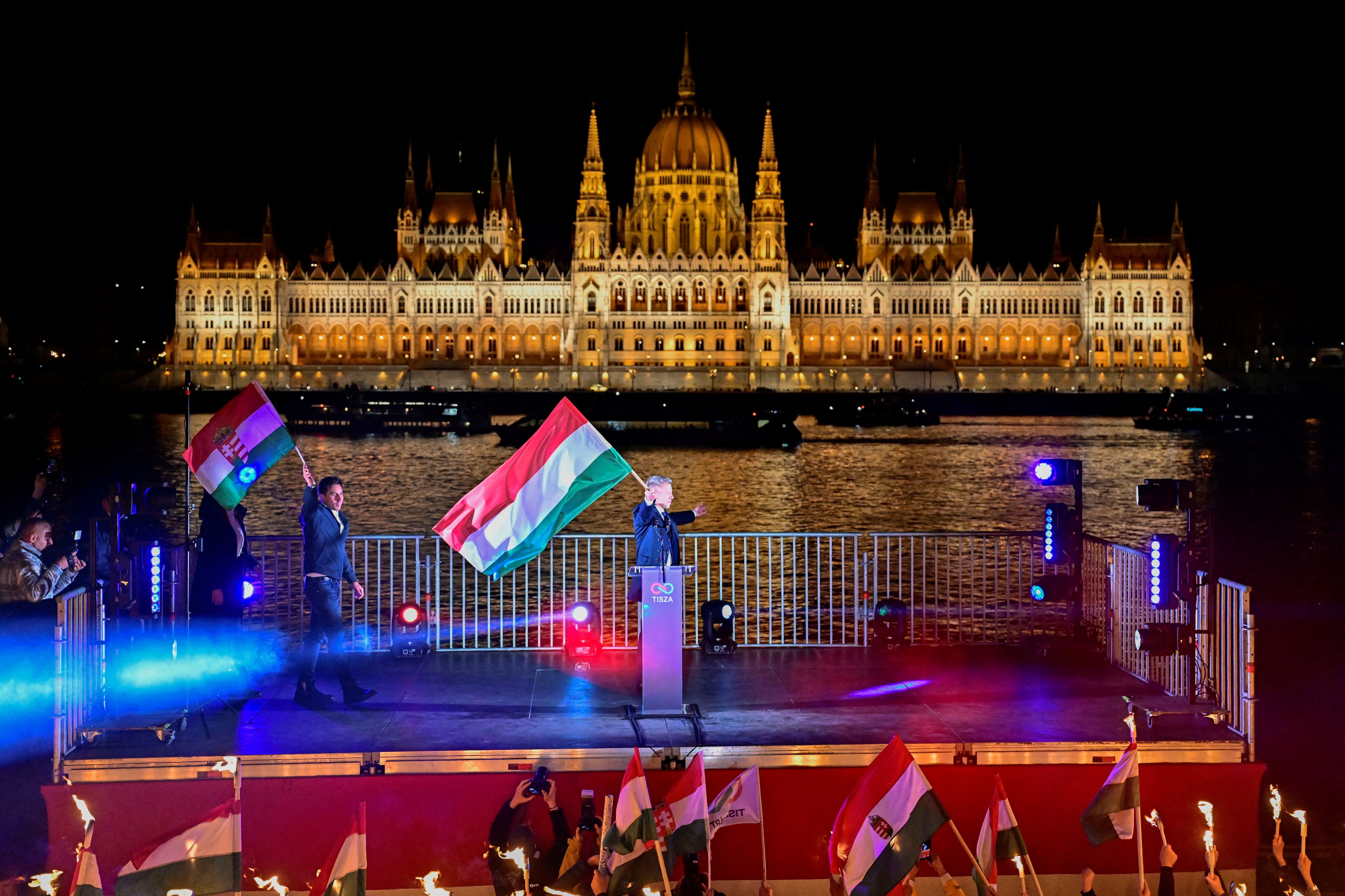 Péter Magyar holds a national flag following the partial results of the parliamentary election