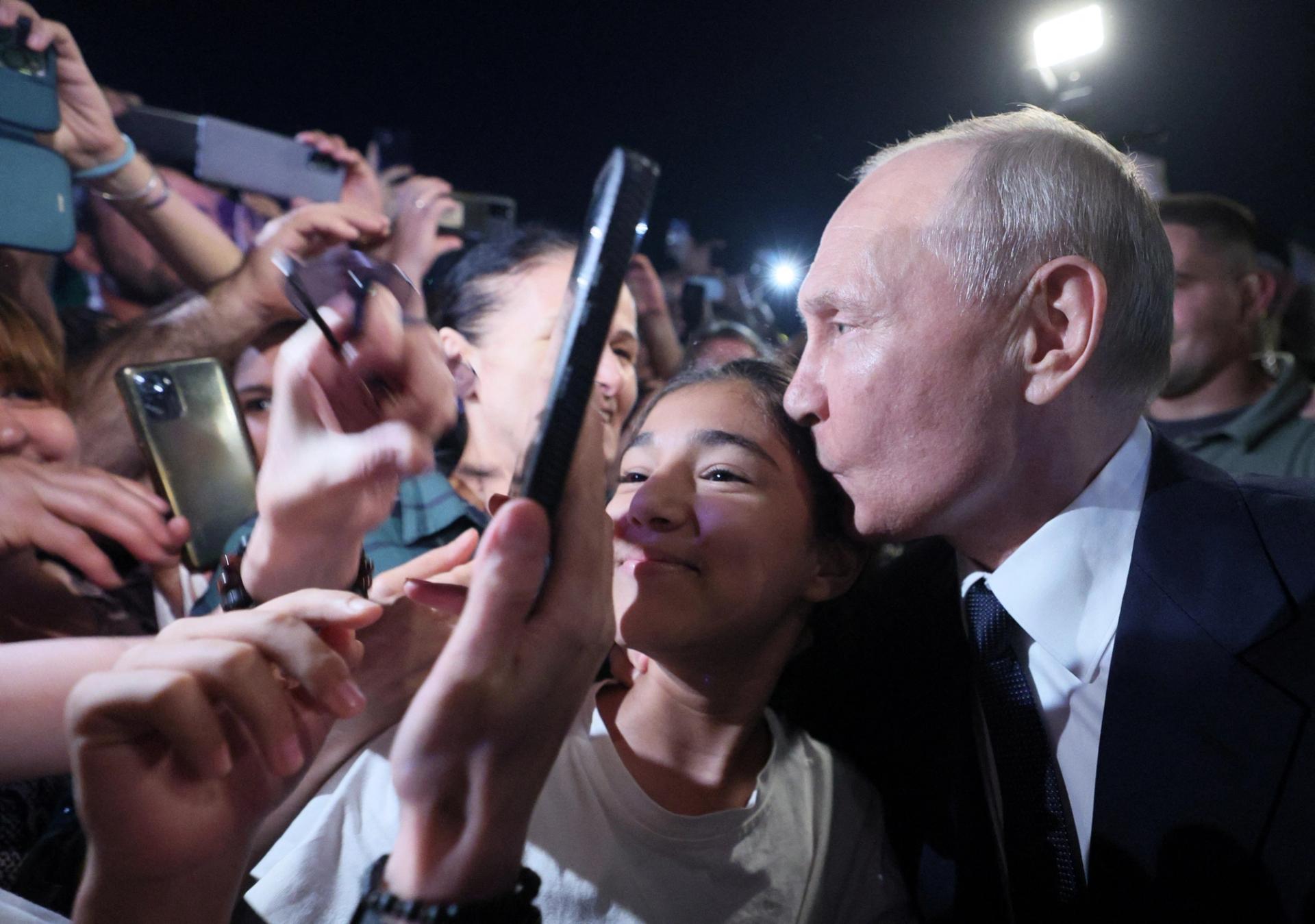 Putin kisses a supporter in a street in Derbent in the southern region of Dagestan, Russia, June 28, 2023.