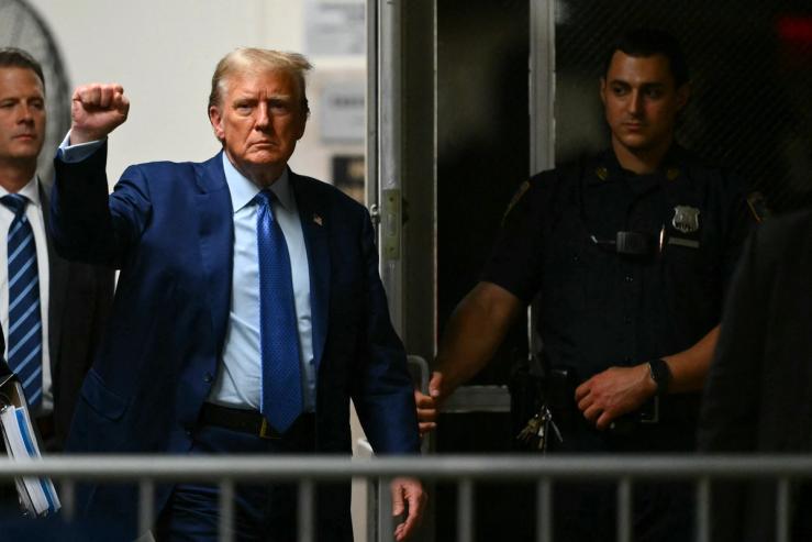Former US President Donald Trump gestures as he walks to the courtroom on May 9, 2024.
