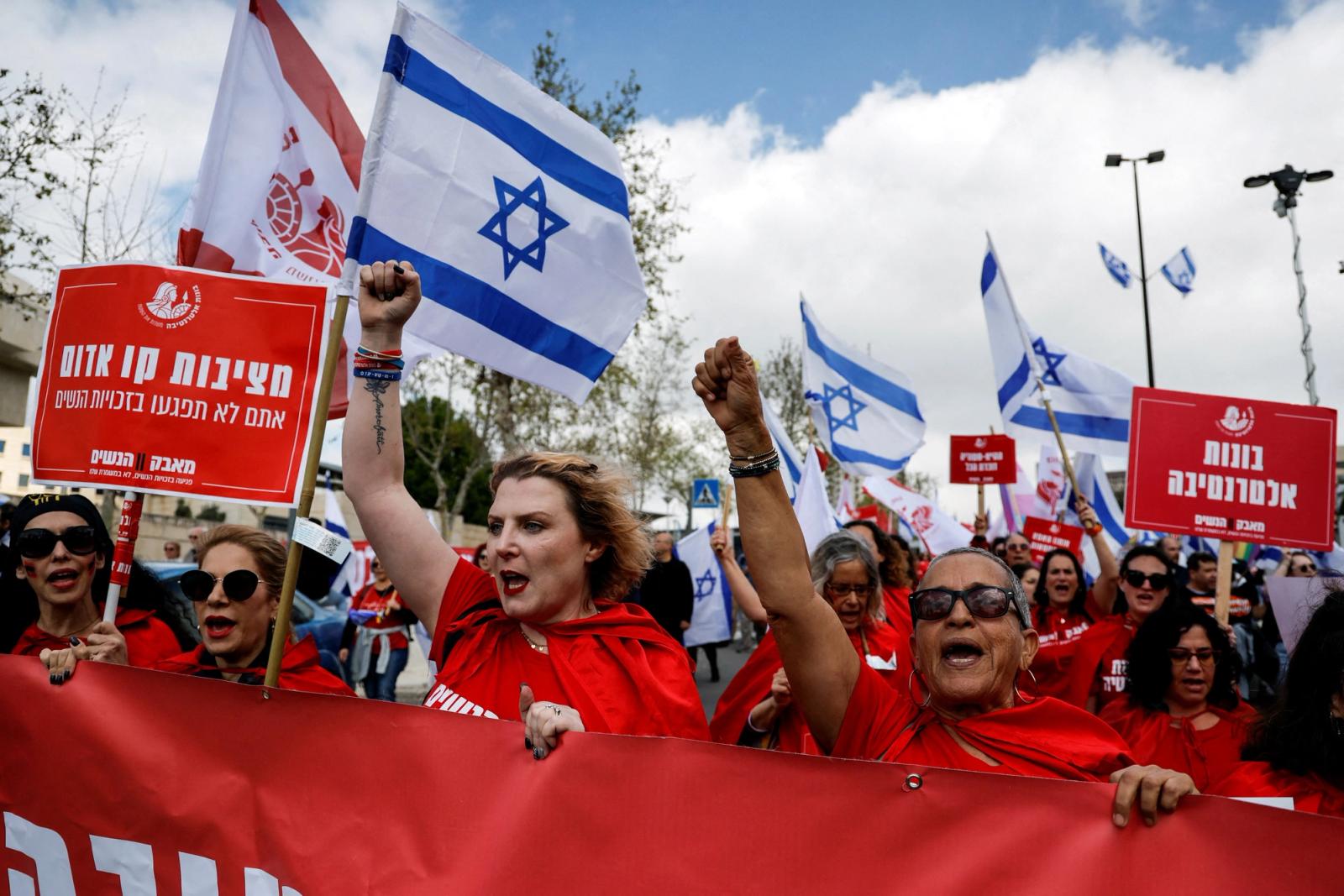 Women dressed as handmaidens from "The Handmaid's Tale" attend a demonstration after Israeli Prime Minister Benjamin Netanyahu dismissed the defense minister and his nationalist coalition government presses on with its judicial overhaul, in Jerusalem, March 27, 2023. REUTERS/Ammar Awad TPX IMAGES OF THE DAY