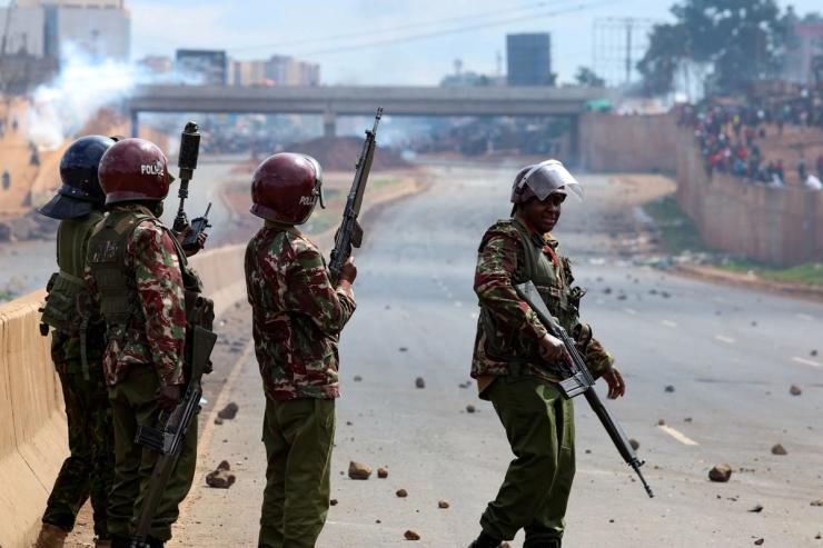 Riot police officers stand during the “Saba Saba People’s March” anti-government protest, in Kangemi area of Nairobi, Kenya.