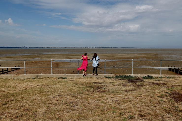 People look out to the Thames Estuary.