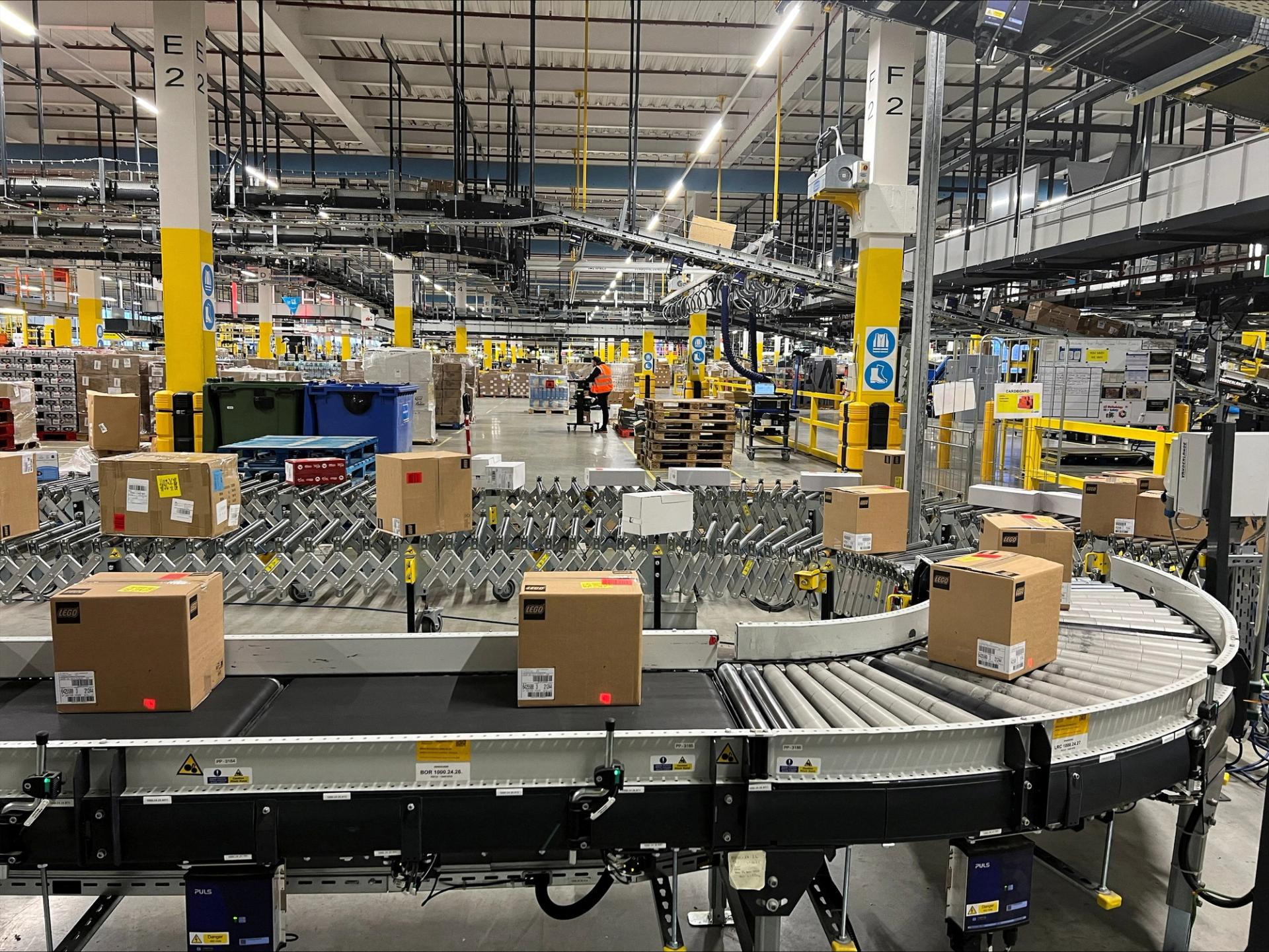 Lego boxes are seen on a conveyor belt at an Amazon warehouse.