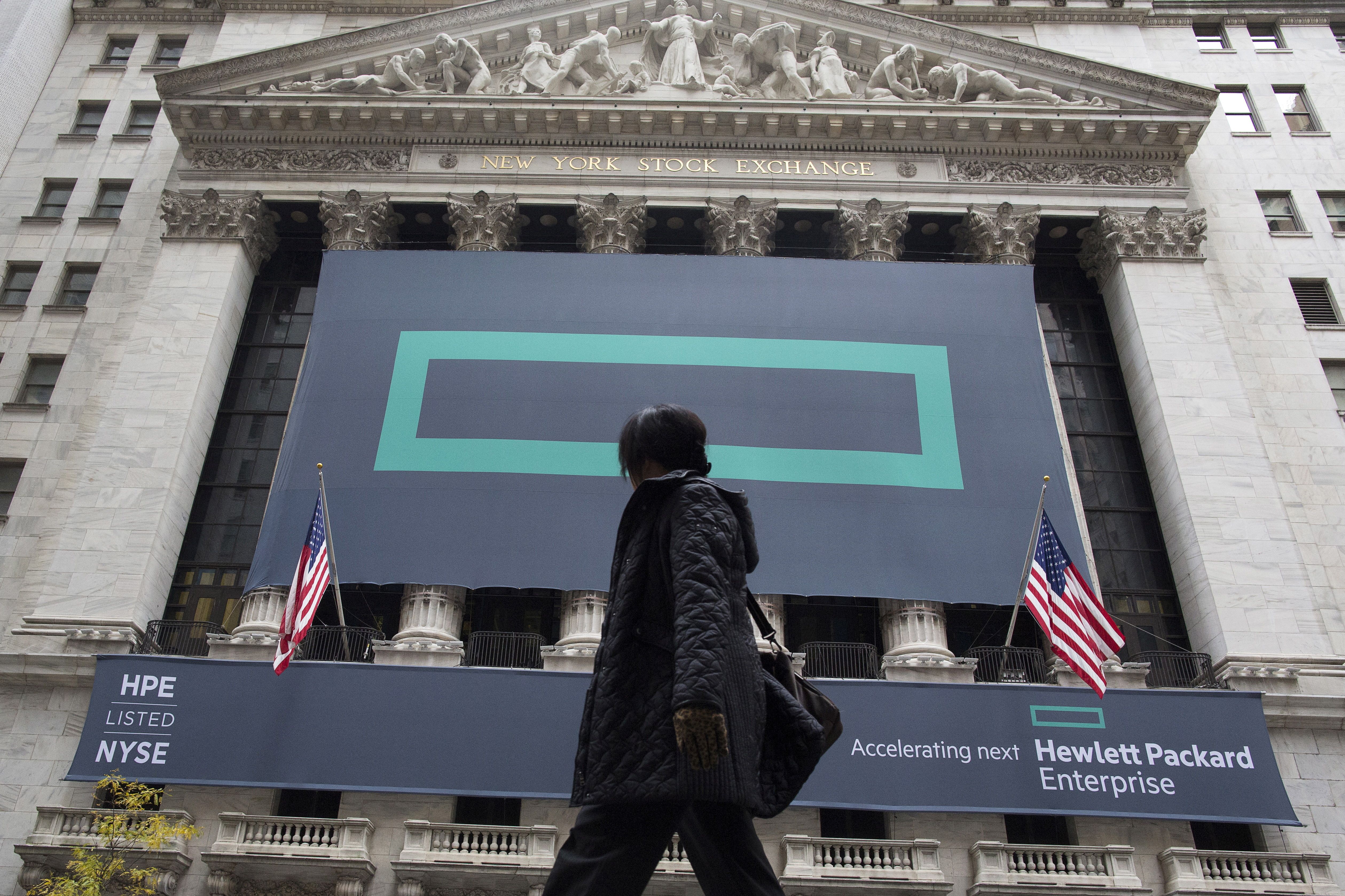 Signs for Hewlett Packard Enterprise Co. cover the facade of the New York Stock Exchange.