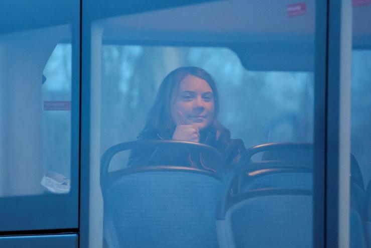 Greta Thunberg gestures as she sits in a bus during the coal mine protest in Luetzerath, Germany, on Jan. 17, 2023