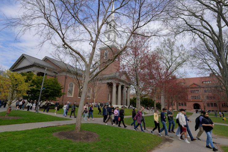 Students walk on the campus of Harvard University in Cambridge, Massachusetts, US.
