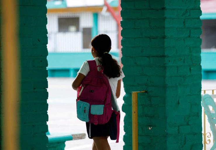 A girl enters her school.