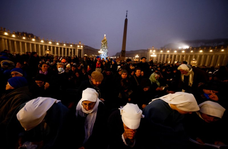 Faithful wait on the day of the funeral of former Pope Benedict in St. Peter's Square at the Vatican.