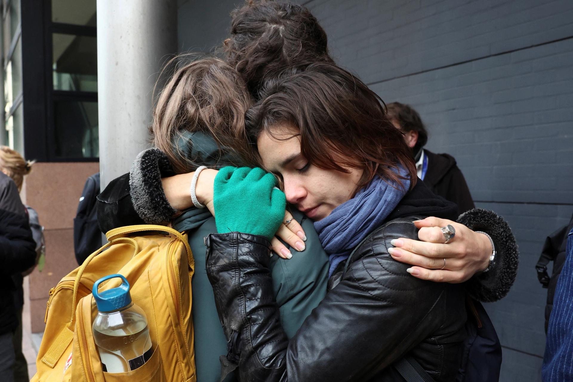 Supporters of Friends of the Earth hug each other as they react to the Dutch court’s ruling in The Hague, Netherlands.