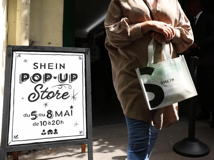 A woman leaves a pop-up store of Chinese fast-fashion retailer Shein in Paris, France