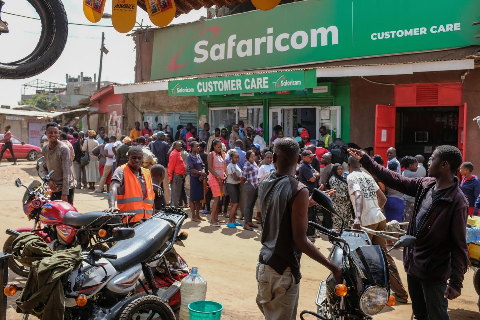 Locals queue up outside a Safaricom customer care shop. 