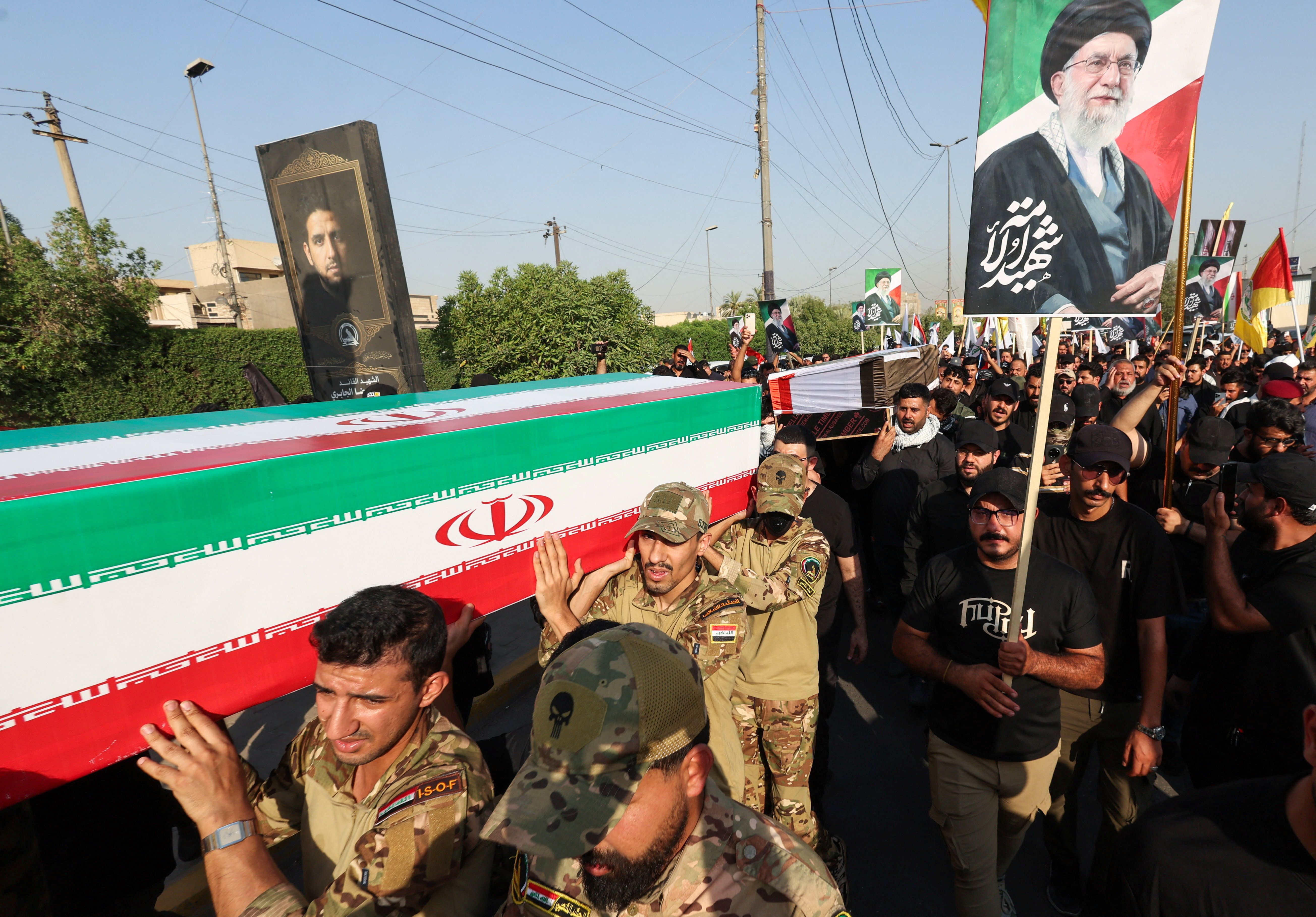 Mourners carry the coffins of members of Iraqi Popular Mobilization Forces