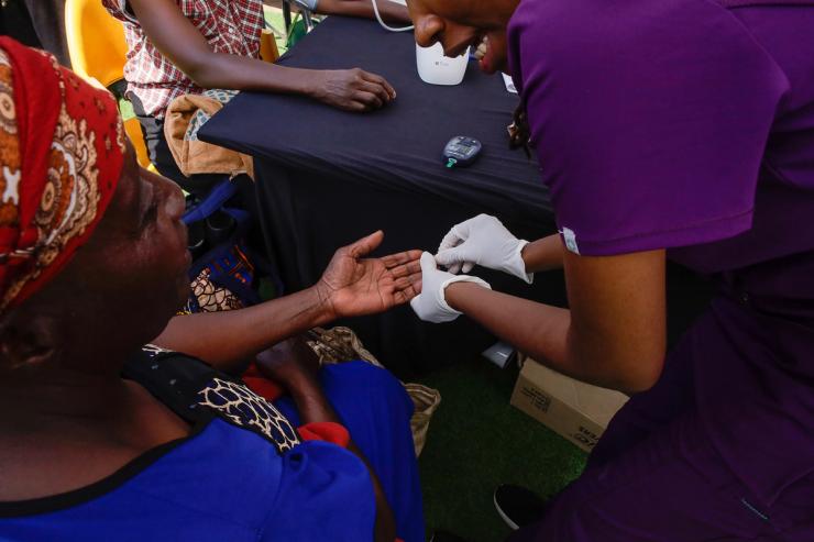 A woman receives free diabetes blood test in Nairobi.
