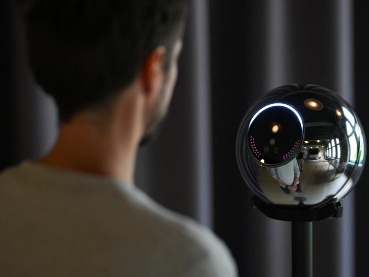 Ricardo Macieira, regional manager, Europe stands to simulate the iris scan near the biometric imaging device, the Orb of the identity and financial public utility Worldcoin, to create a World ID digital passport, being able to trade in cryptocurrency issued, in Berlin, Germany August 1, 2023.