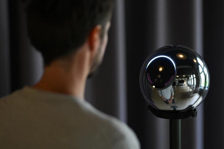 Ricardo Macieira, regional manager, Europe stands to simulate the iris scan near the biometric imaging device, the Orb of the identity and financial public utility Worldcoin, to create a World ID digital passport, being able to trade in cryptocurrency issued, in Berlin, Germany August 1, 2023.