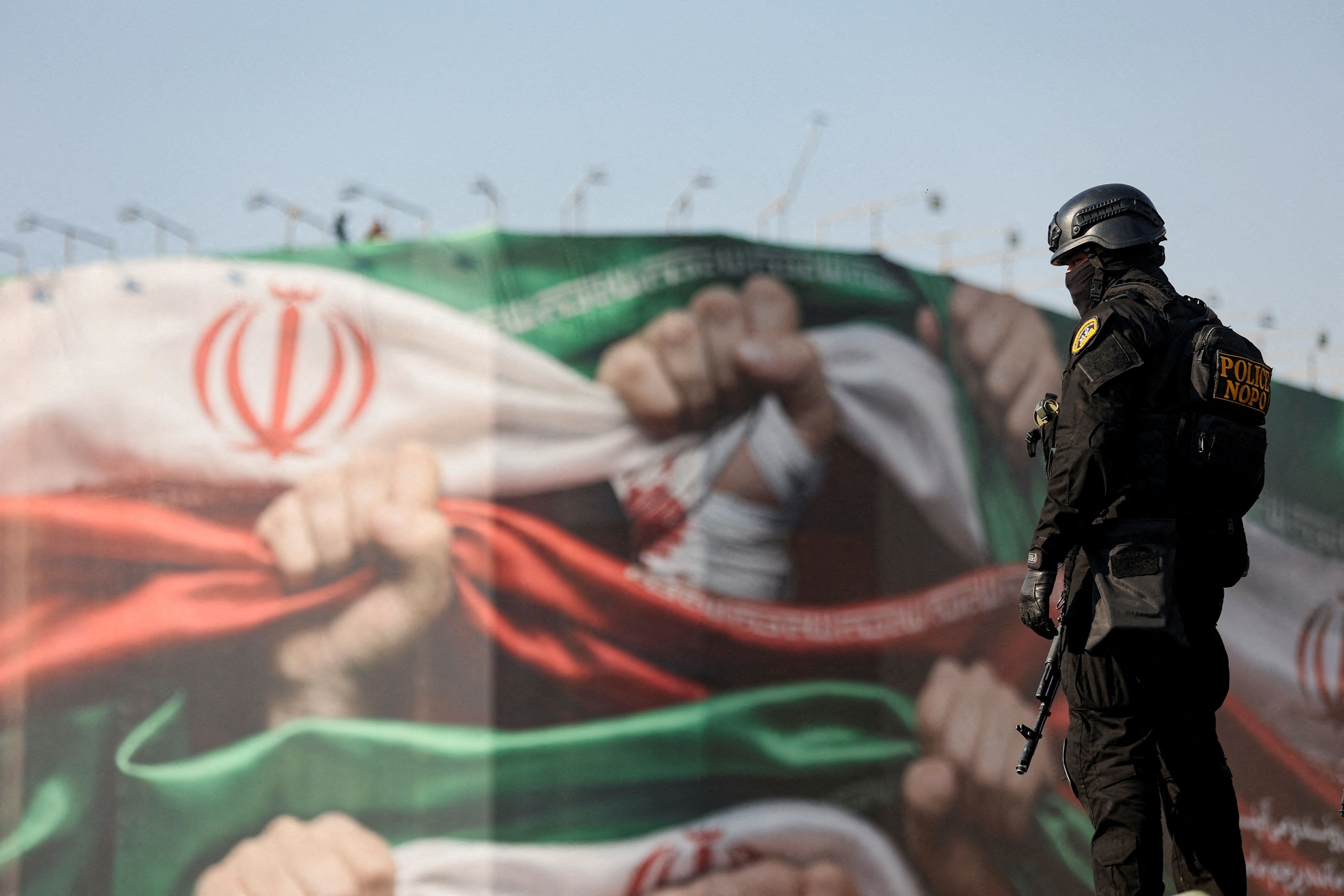 A member of the Iranian police attends a pro-government rally in Tehran