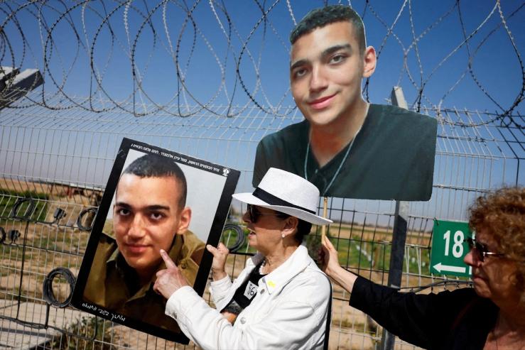 Varda Ben Baruch, grandmother of hostage Edan Alexander, points at the portrait of Edan.