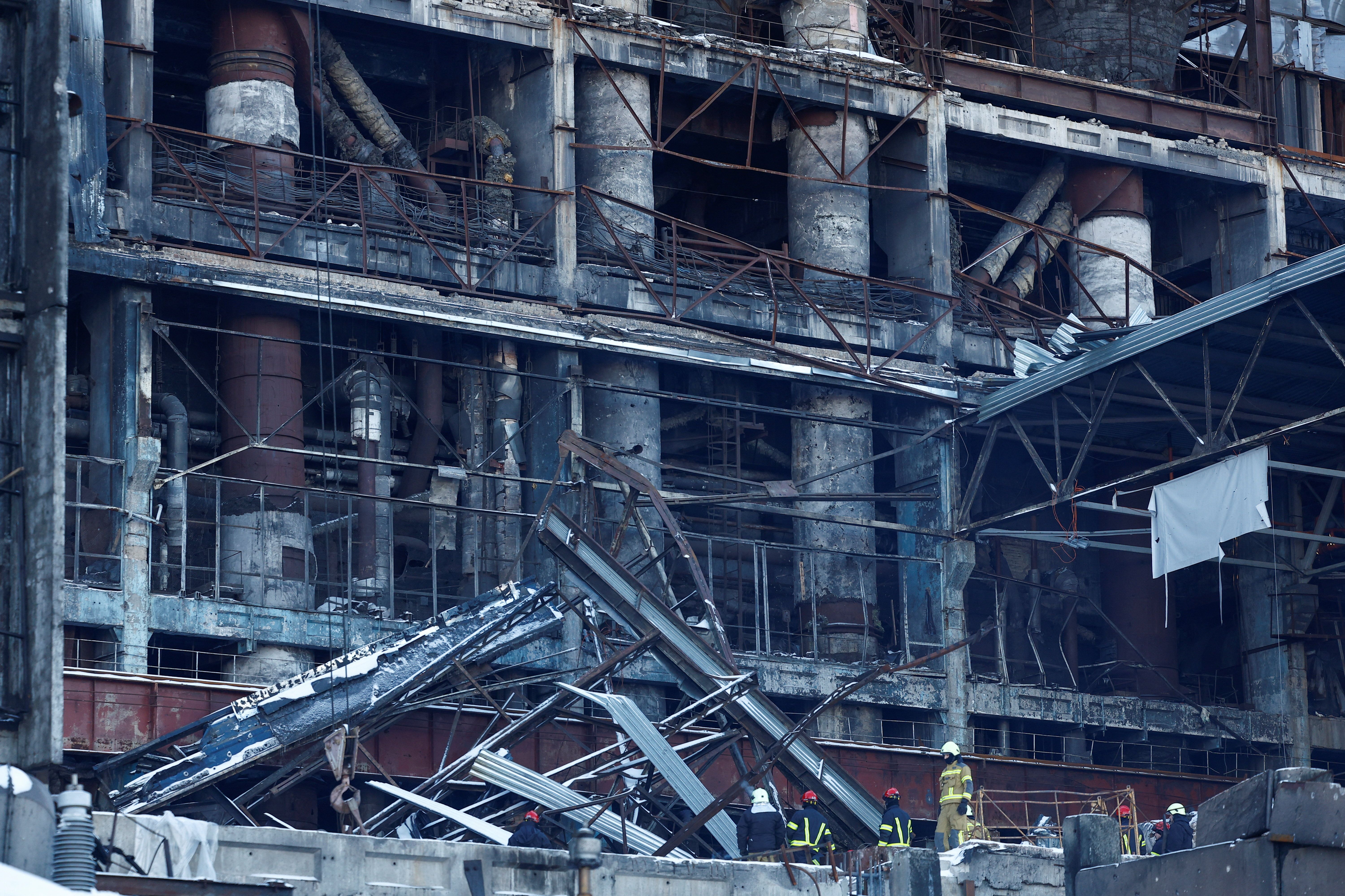 Rescuers remove debris at a thermal power plant damaged by Russian missile strikes in Ukraine.