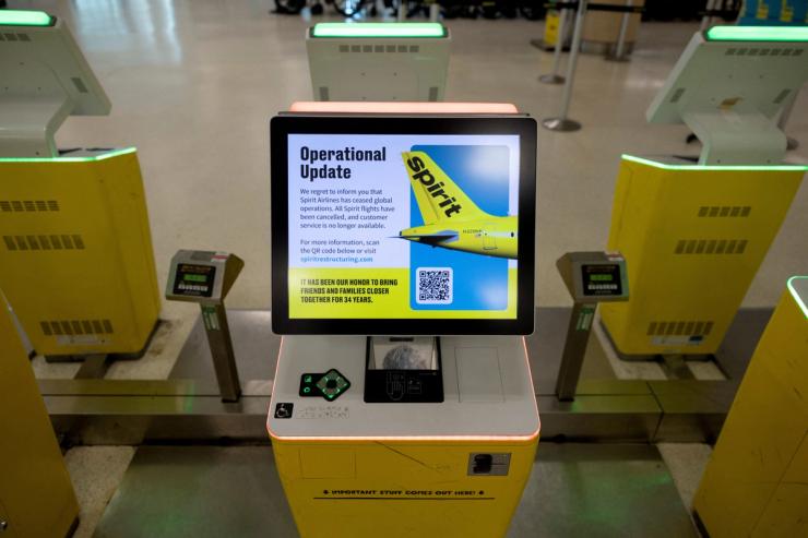 A self-check-in kiosk displays an “Operational Update” message after Spirit Airlines announced it was ceasing operations