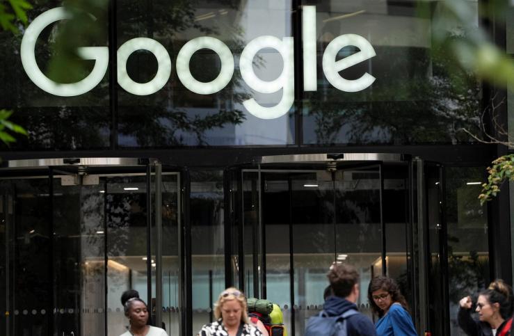 People stand outside the Google offices in London.