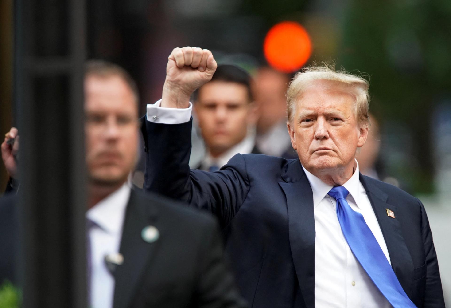 Former U.S. President Donald Trump pumps a fist outside Trump Tower after the verdict in his criminal trial on May 30, 2024.