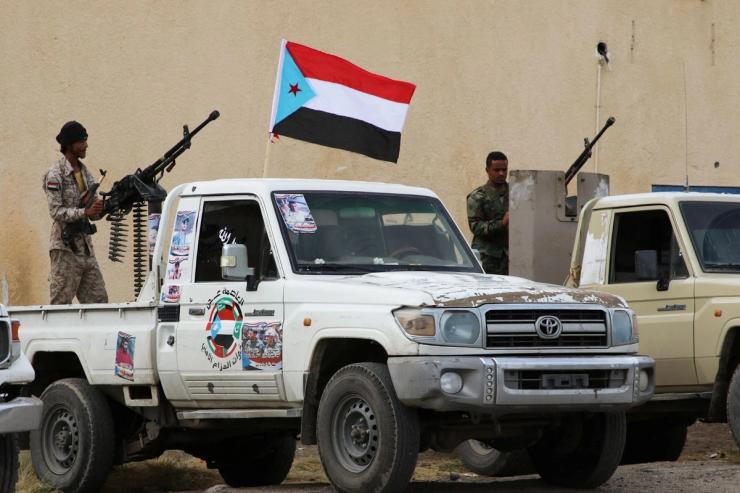 Security forces loyal to the separatist Southern Transitional Council hold weapons while standing at the back of vehicles as they are deployed in the southern port city of Aden.