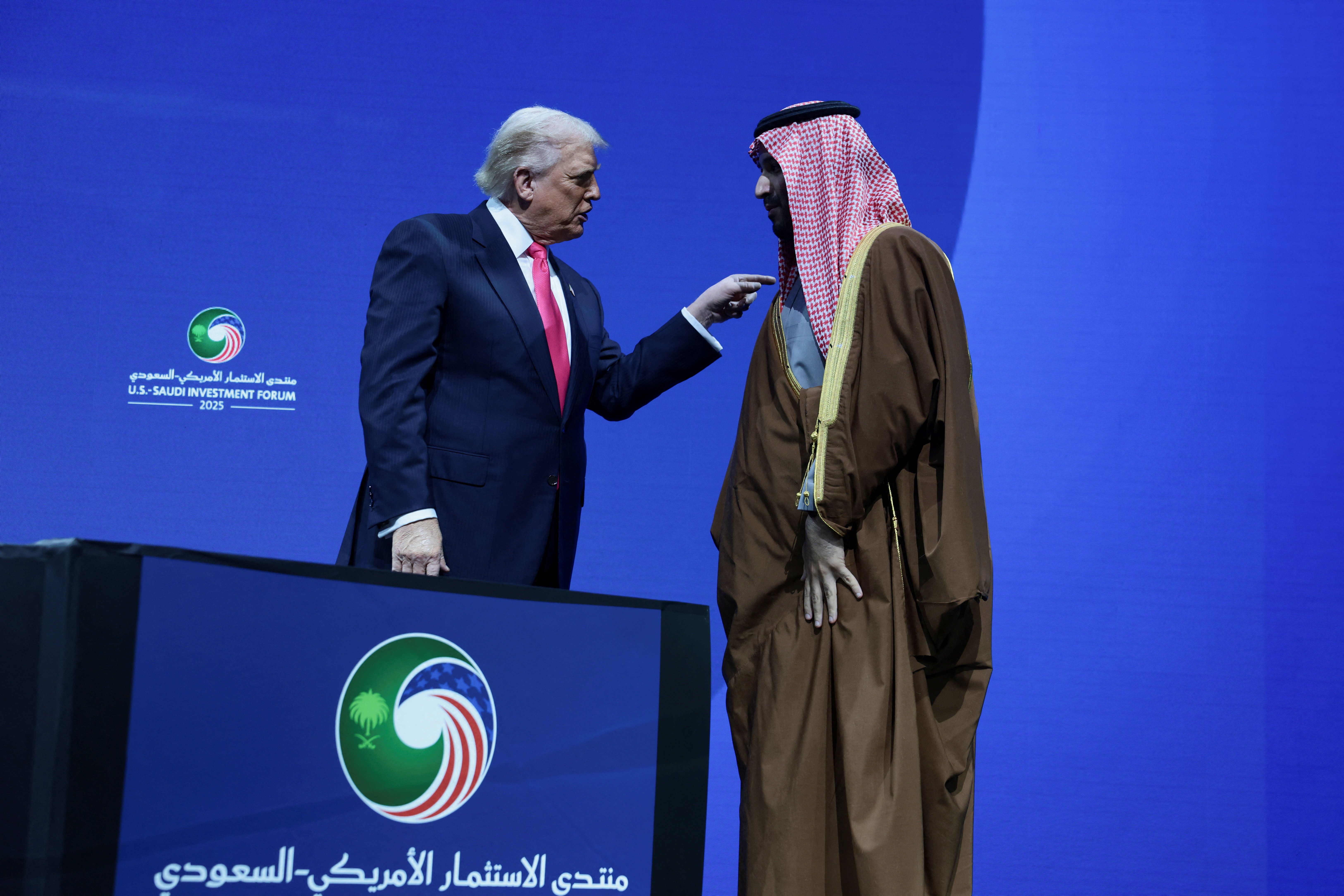 U.S. President Donald Trump and Crown Prince and Prime Minister Mohammed bin Salman of Saudi Arabia interact during the U.S.-Saudi Investment Forum in Washington.