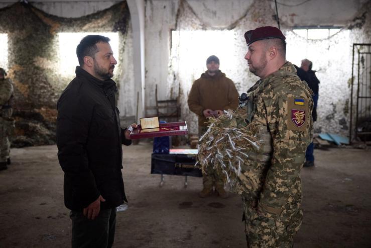 Ukraine’s President Volodymyr Zelenskiy awards a Ukrainian serviceman as he visits a position in a front line near Kupiansk, amid Russia’s attack on Ukraine, in Kharkiv region, Ukraine February 19, 2024. Ukrainian Presidential Press Service/Handout via REUTERS