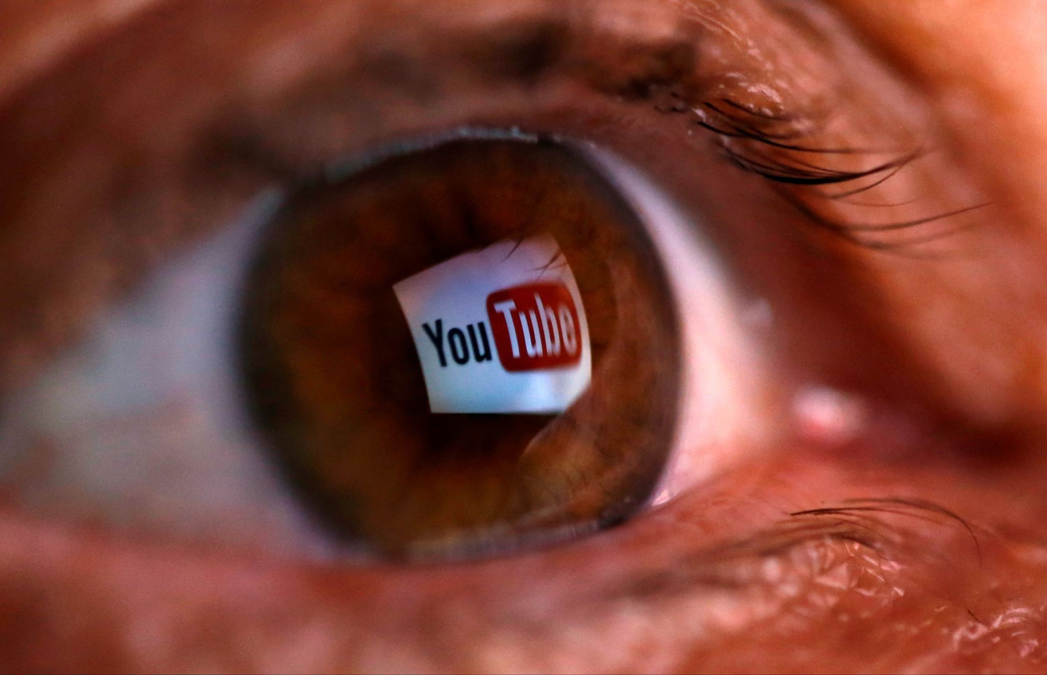 YouTube’s logo reflected in a person’s eyeball