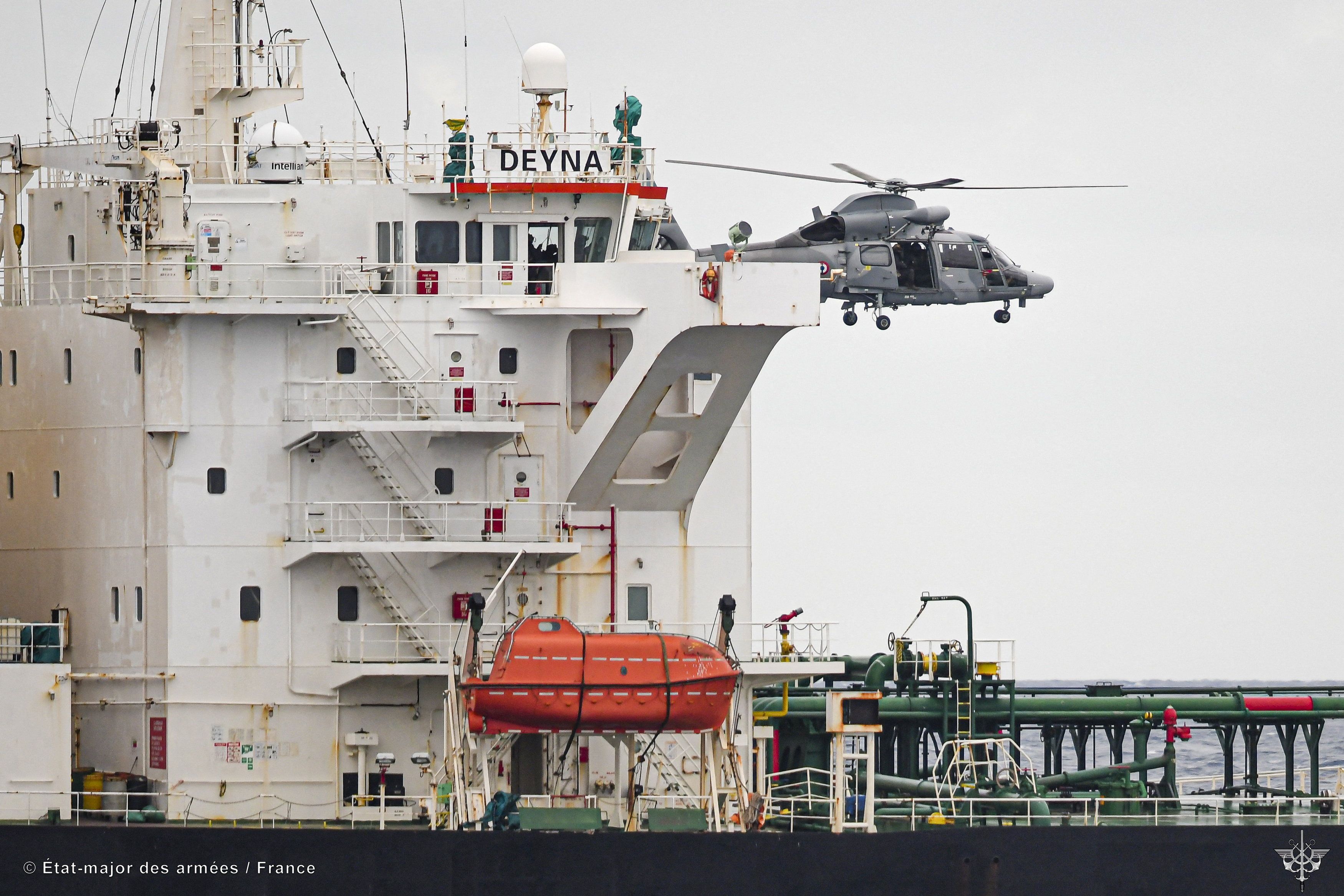 A French Navy helicopter hovers over the Deyna vessel, which is supposed to be a member of the Russian shadow fleet.