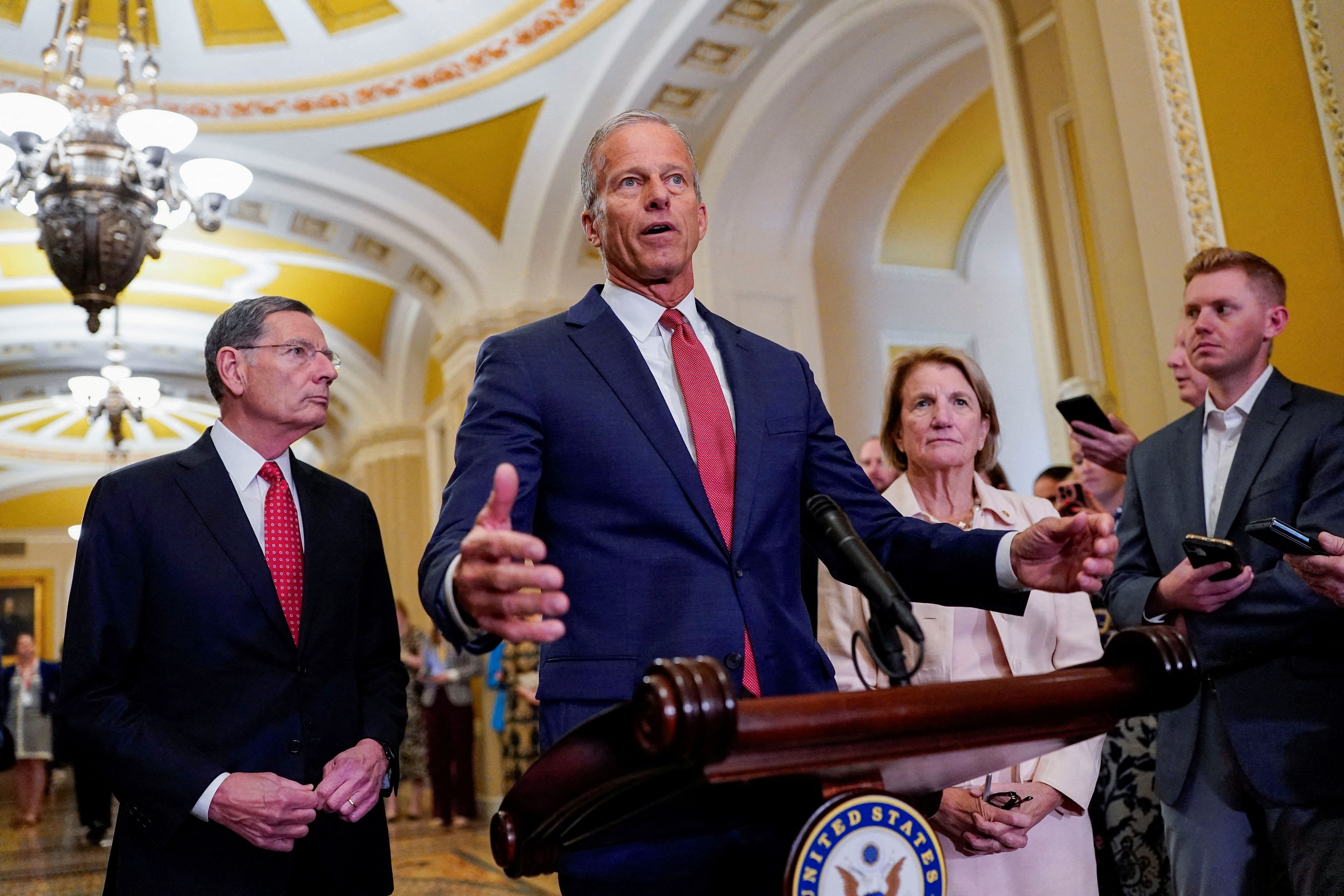 U.S. Senate Majority Leader John Thune looks on as Senate Republican leaders hold a press conference.